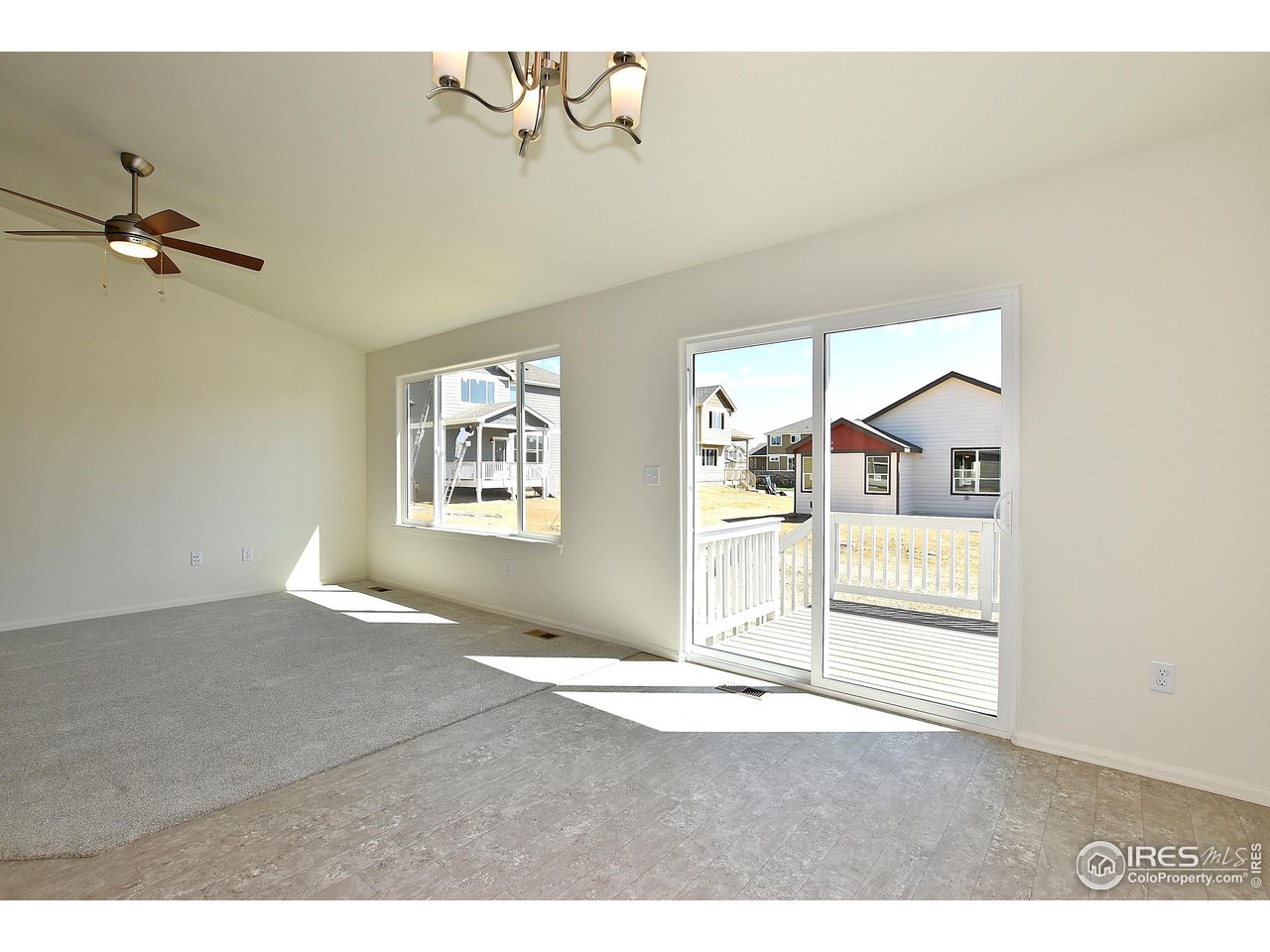 2335 Sublime Drive Windsor, CO 80550 - Photo 19 of 39 a view of a big room with chandelier fan and windows