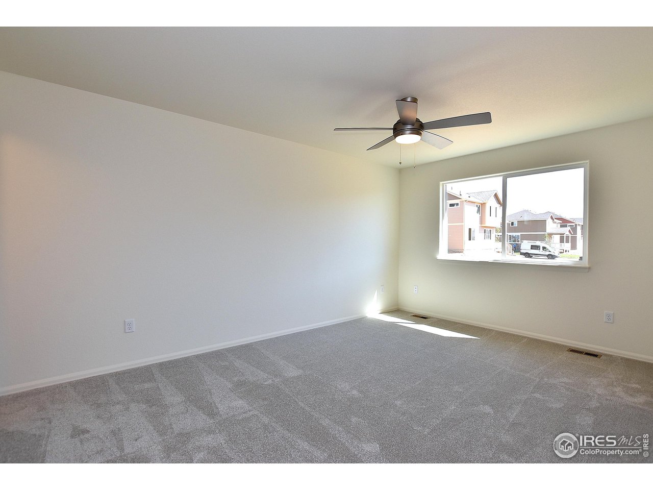 2335 Sublime Drive Windsor, CO 80550 - Photo 25 of 39 an empty room with windows and fan