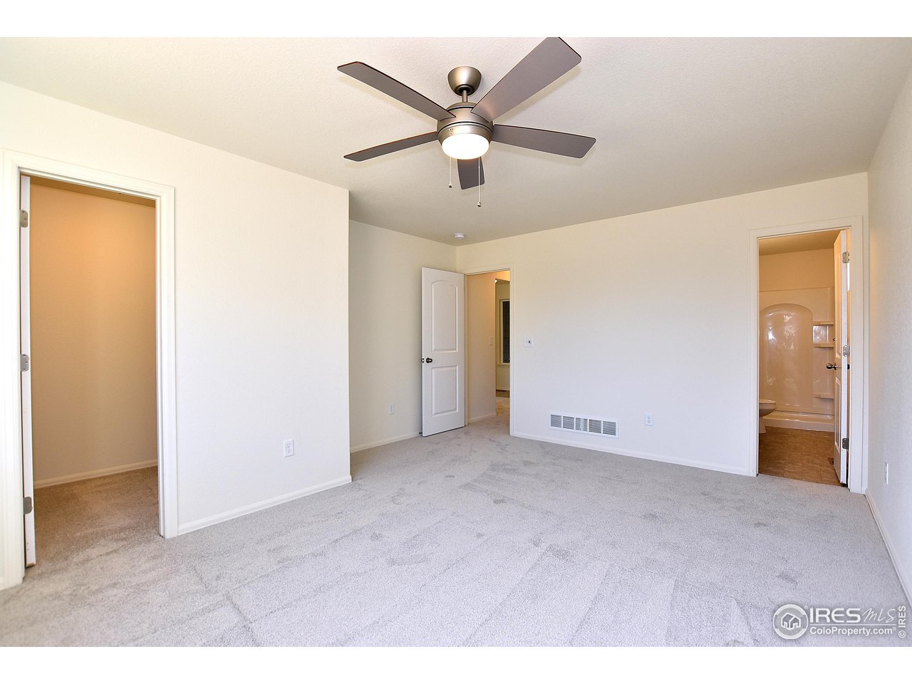 2335 Sublime Drive Windsor, CO 80550 - Photo 31 of 39 a view of an empty room with a ceiling fan