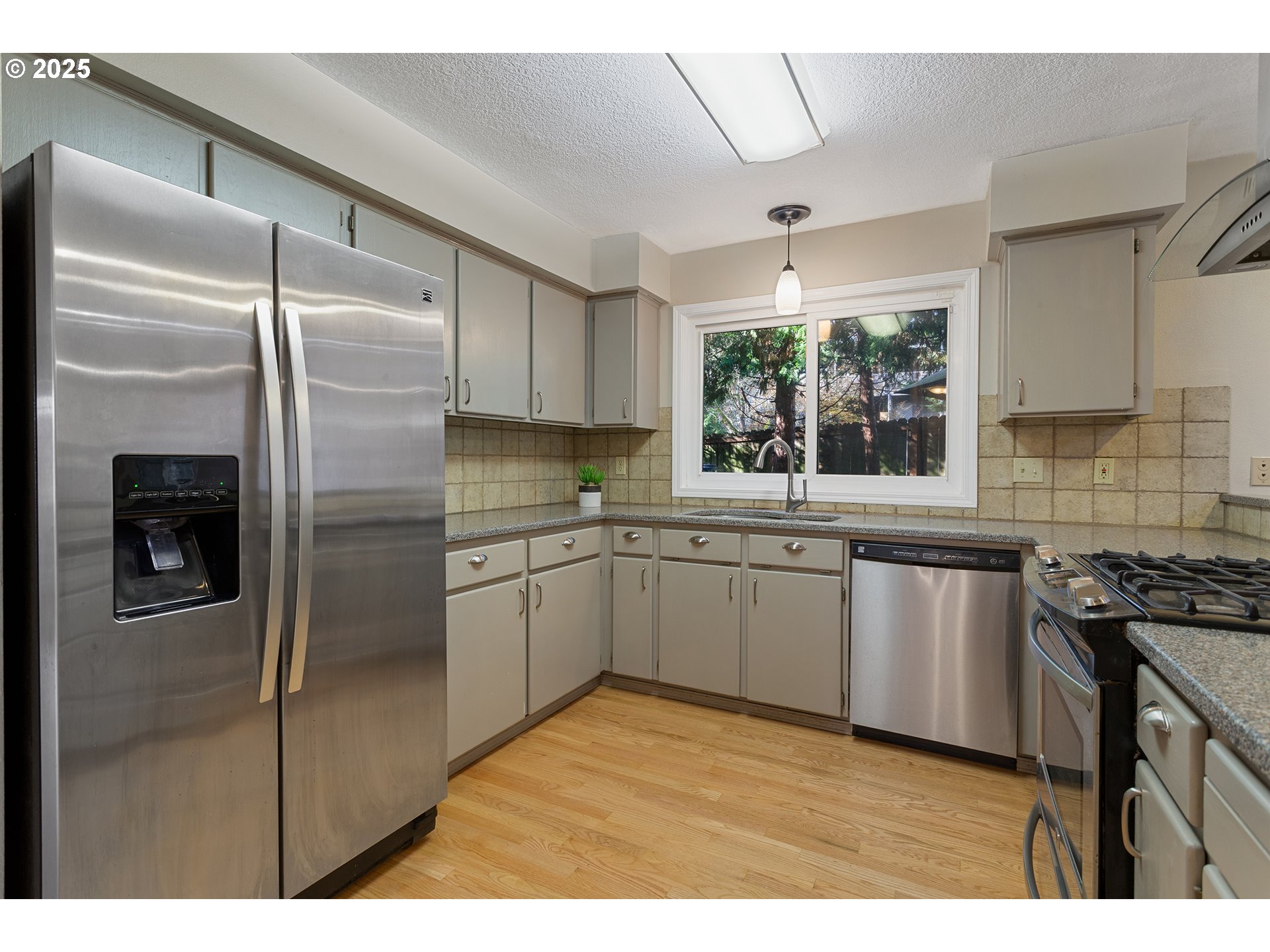 9125 Southwest Davies Road Beaverton, OR 97008 - Photo 12 of 44 a kitchen with a refrigerator sink and stove
