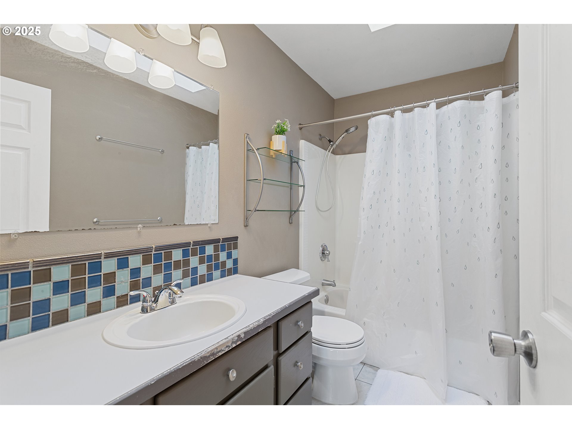 9125 Southwest Davies Road Beaverton, OR 97008 - Photo 32 of 44 a bathroom with a sink toilet a mirror and shower