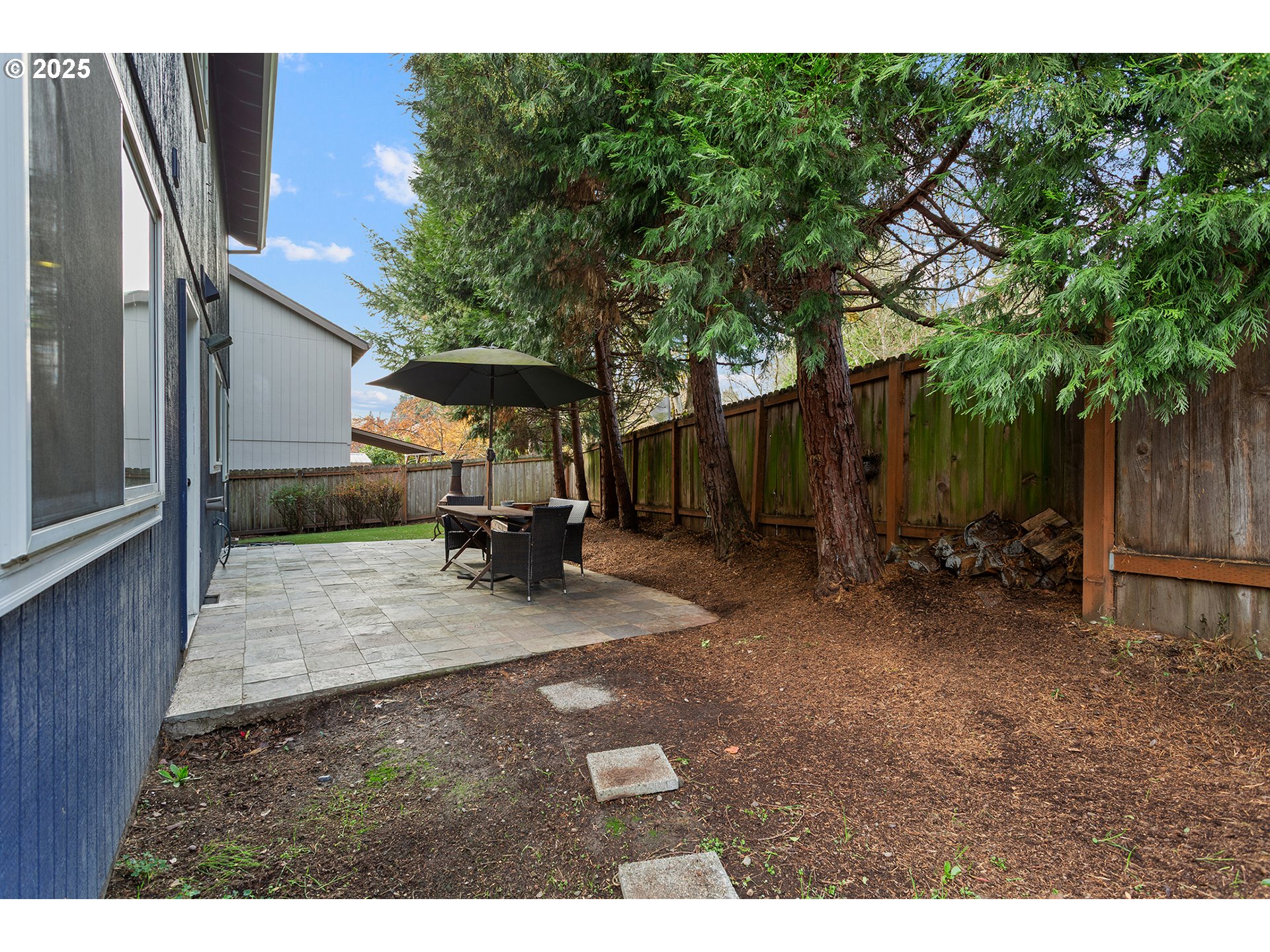 9125 Southwest Davies Road Beaverton, OR 97008 - Photo 34 of 44 a view of a backyard with sitting area and tree