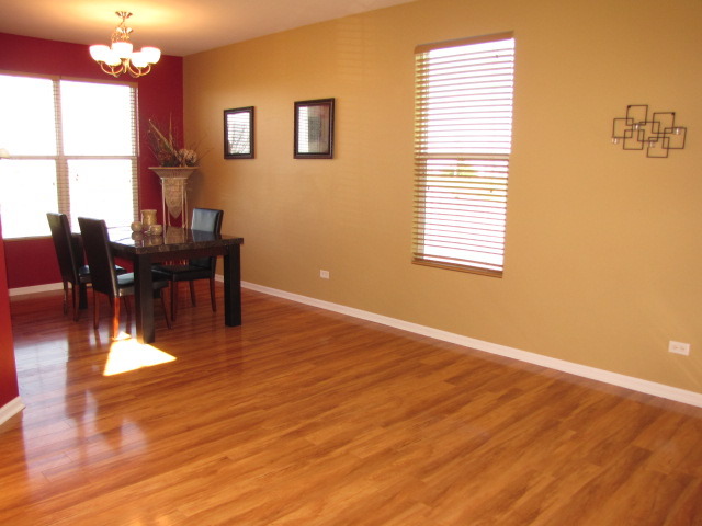 6403 Roth Court Joliet, IL 60431 - Photo 3 of 22 a view of a dining room with furniture window and wooden floor