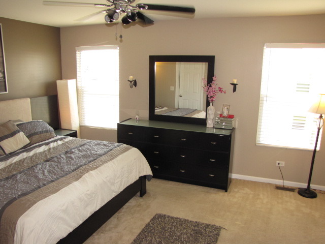 6403 Roth Court Joliet, IL 60431 - Photo 10 of 22 a bedroom with a bed and a mirror on dresser