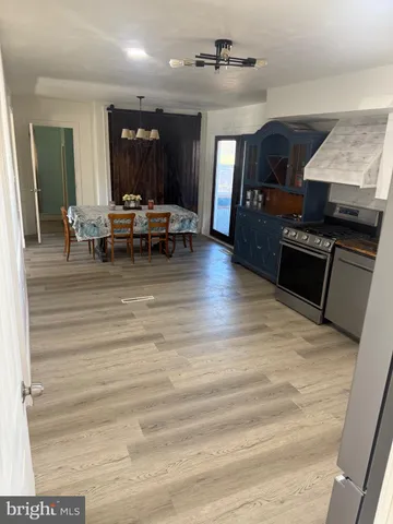 a bedroom with furniture a flat screen tv and a window