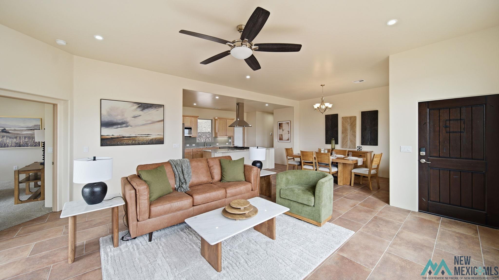 119 Mesa Grande Road Elephant Butte, NM 87935 - Photo 1 of 34 Living room with a chandelier, a ceiling fan, and light tile patterned floors