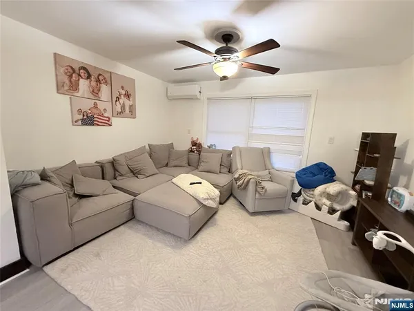 a living room with furniture and ceiling fan
