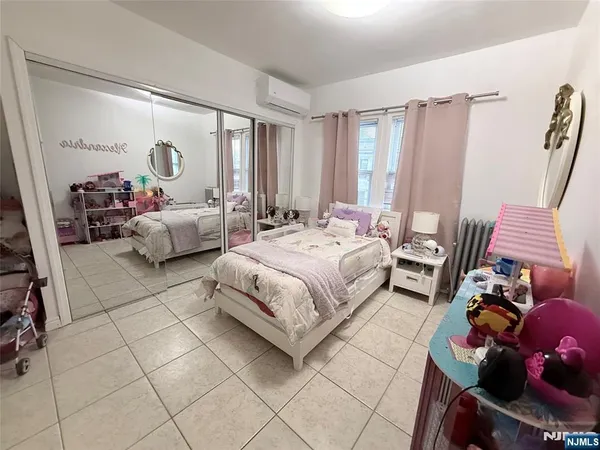 a spacious bedroom with a bed and a couch