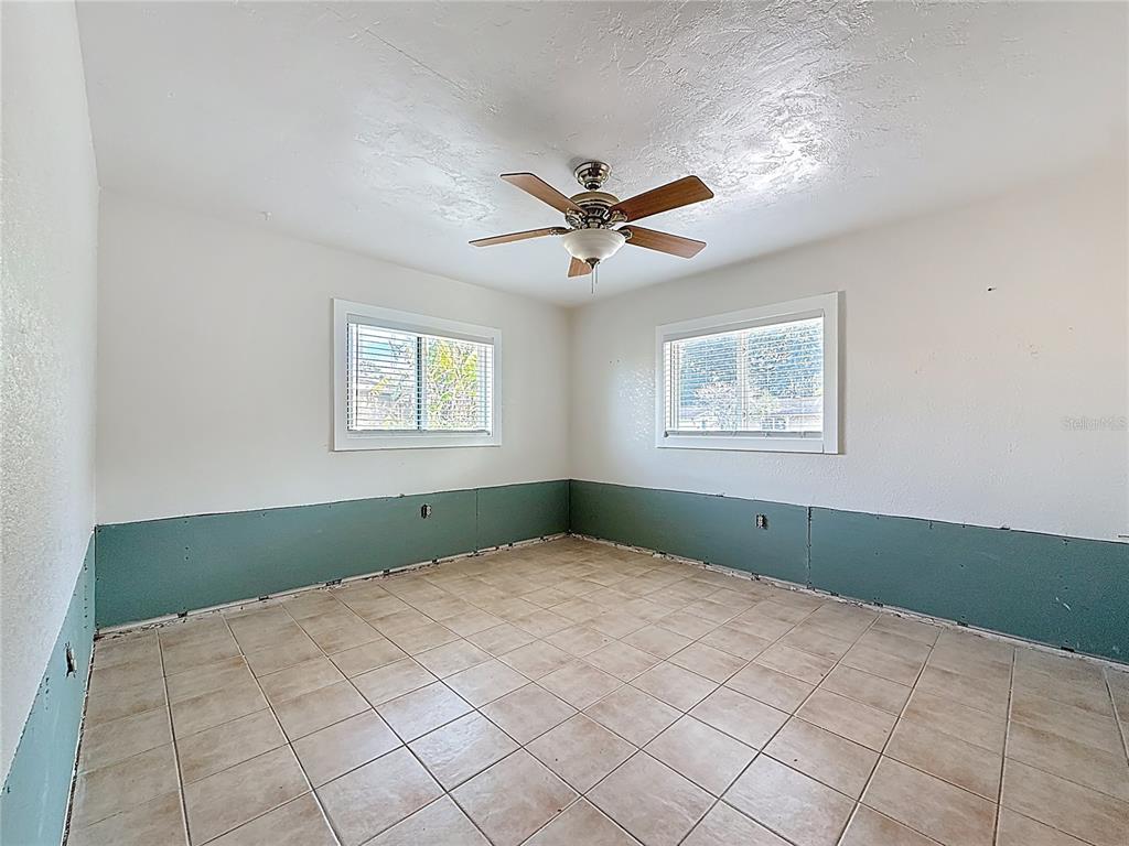 4869 Shell Stream Boulevard New Port Richey, FL 34652 - Photo 22 of 46 a bedroom with a bed and a window