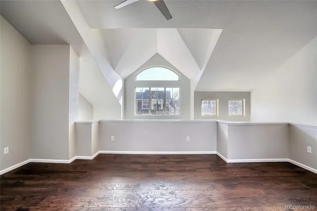 a kitchen with stainless steel appliances a refrigerator and a wooden floor