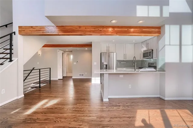 a bathroom with a sink a toilet and a large mirror