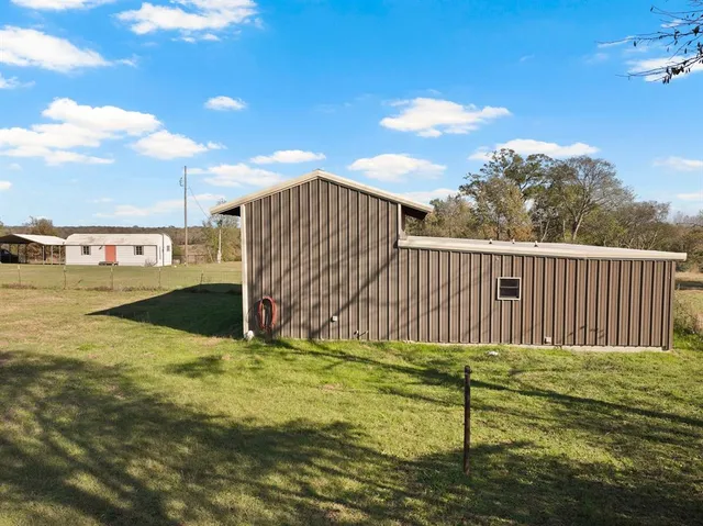 a view of a backyard with fence
