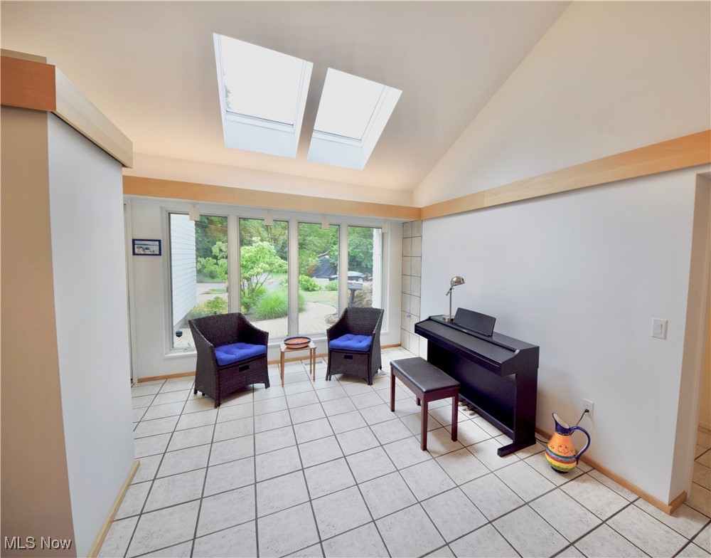 3559 Birchtree Path Cleveland, OH 44121 - Photo 4 of 37 Sitting room featuring a skylight, light tile patterned floors, and lofted ceiling
