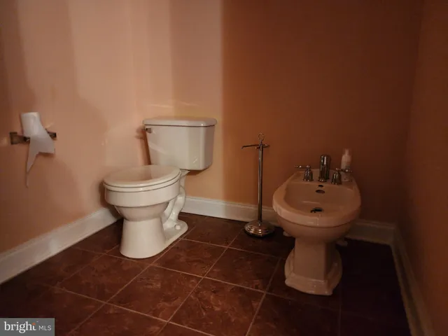 a white toilet sitting next to a bathroom sink