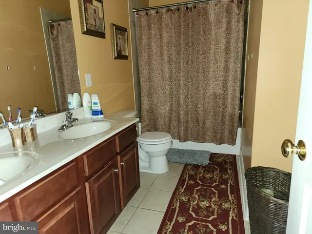 a bathroom with a double vanity sink and mirror