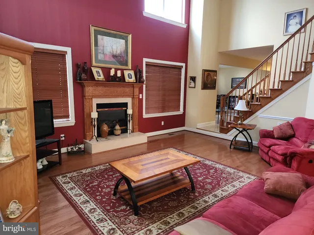 a living room with furniture rug and wooden floor