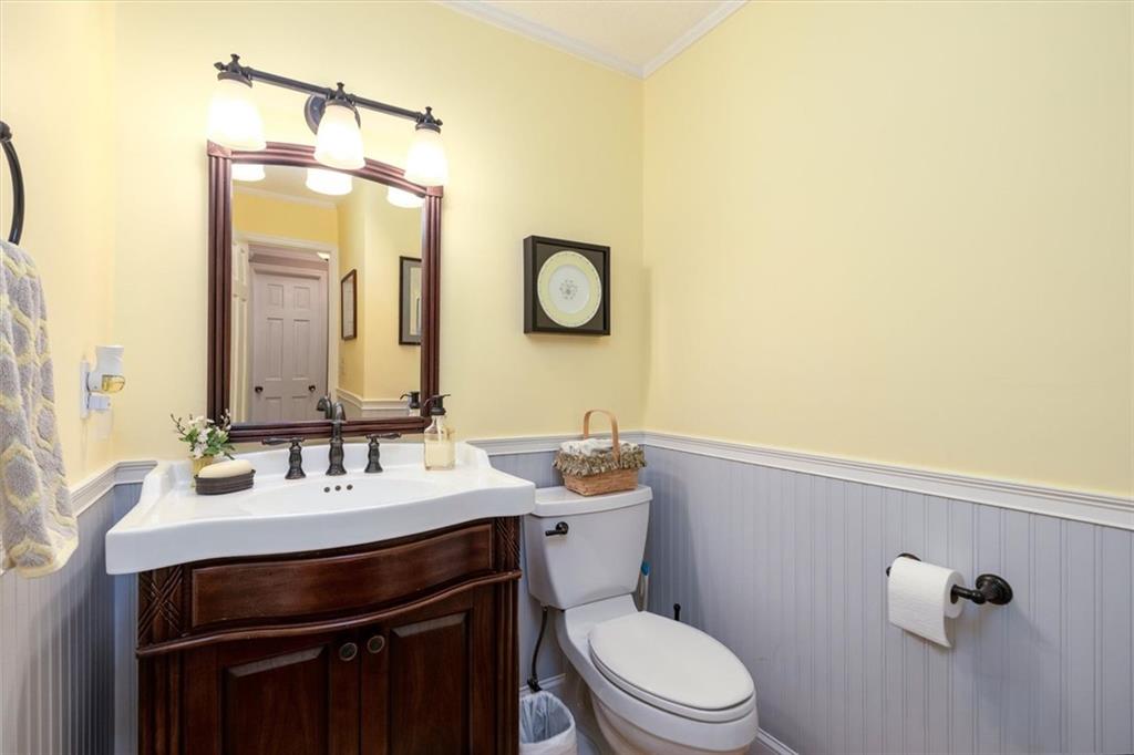 1942 Musket Court Smoke Rise, GA 30087 - Photo 11 of 54 a bathroom with a toilet a sink and mirror