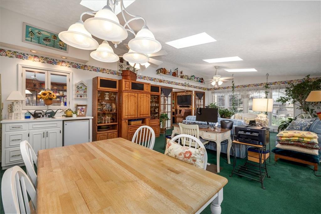 1942 Musket Court Smoke Rise, GA 30087 - Photo 21 of 54 a large white kitchen with lots of counter space and chandelier