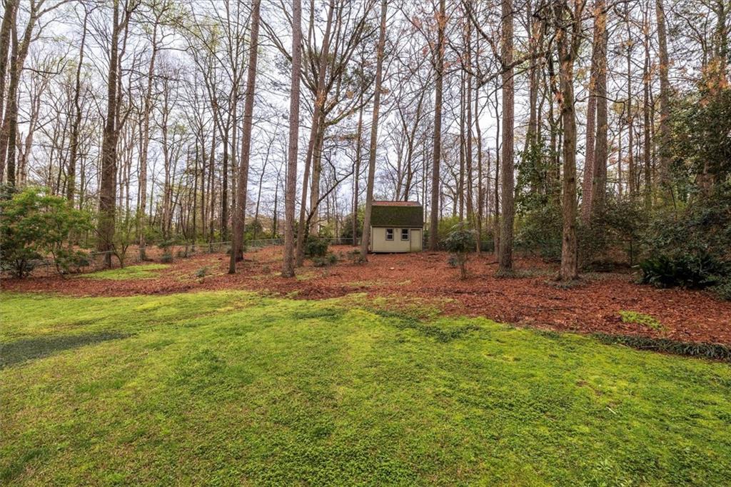 1942 Musket Court Smoke Rise, GA 30087 - Photo 46 of 54 a backyard of a house with lots of green space and fountain