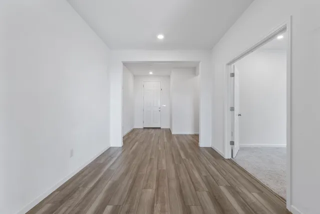 a view of a room with wooden floor