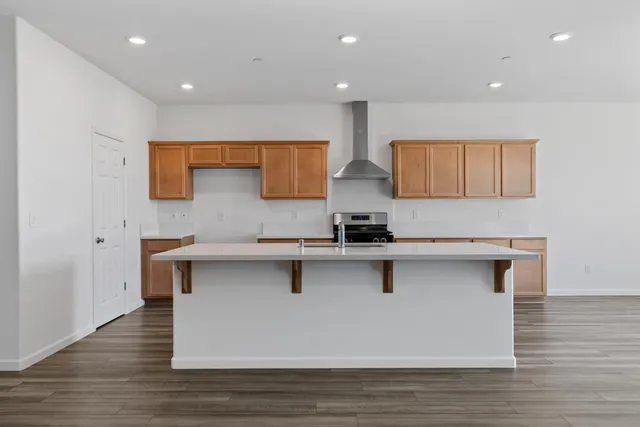 a kitchen with stainless steel appliances granite countertop a sink stove and cabinets