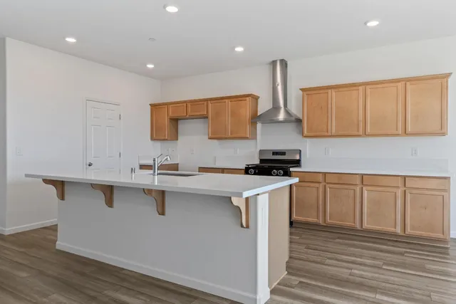 a kitchen with sink a stove and cabinets