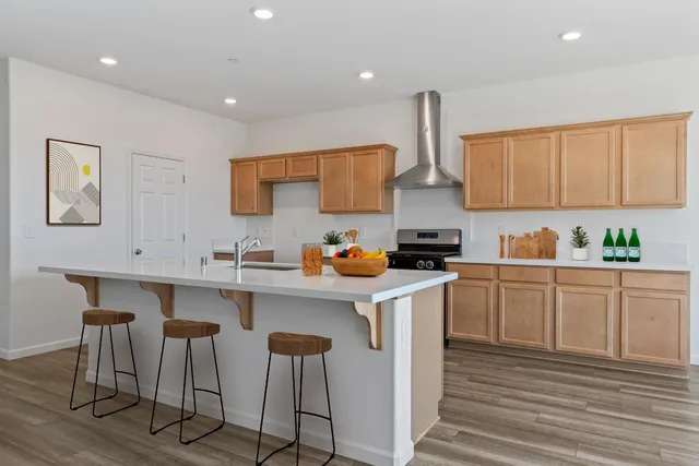 a kitchen with stainless steel appliances granite countertop a sink and cabinets