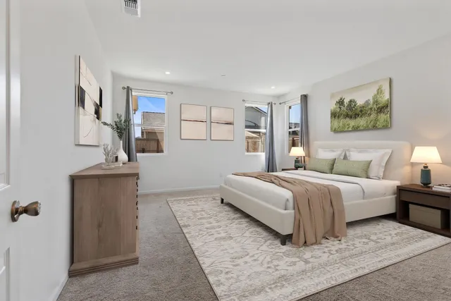 a bedroom with a bed and a couch