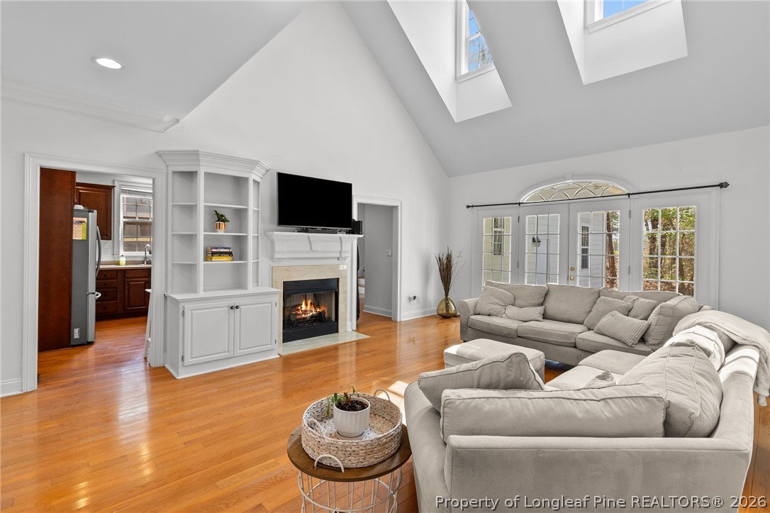 809 Kensington Park Road Fayetteville, NC 28311 - Photo 10 of 12 a living room with furniture a fireplace and a flat screen tv