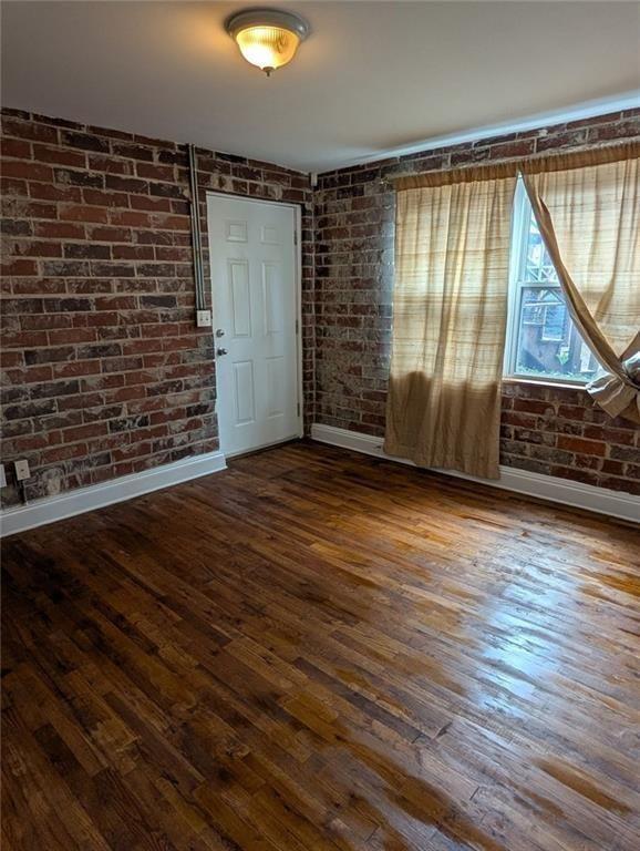 24 Daniel Street Southeast, Unit 4 Atlanta, GA 30312 - Photo 13 of 19 a view of an empty room with wooden floor and a window