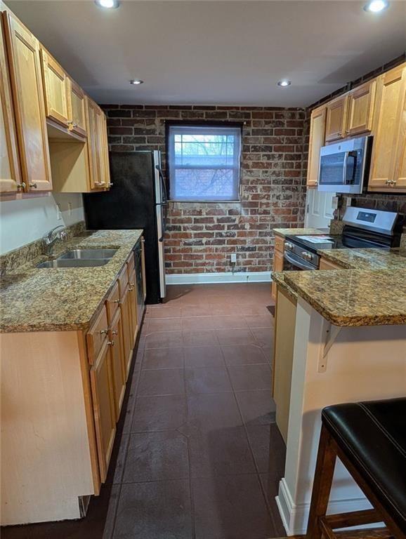 24 Daniel Street Southeast, Unit 4 Atlanta, GA 30312 - Photo 7 of 19 a kitchen with a stove a sink and a refrigerator