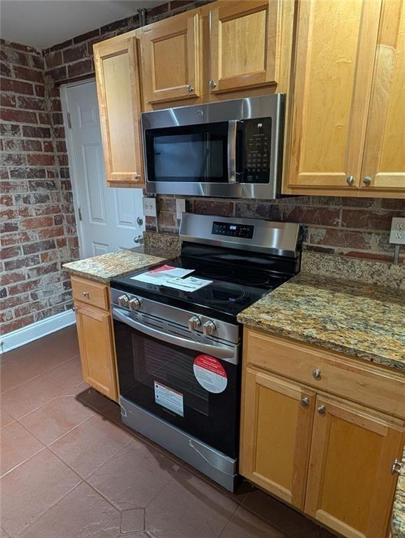 24 Daniel Street Southeast, Unit 4 Atlanta, GA 30312 - Photo 10 of 19 a kitchen with stainless steel appliances granite countertop a stove and a microwave