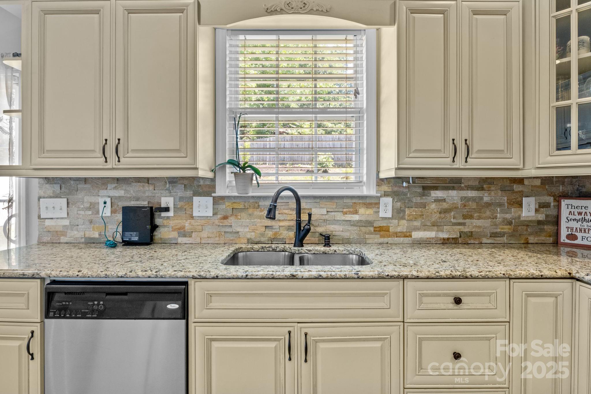 10825 Traders Court Davidson, NC 28036 - Photo 12 of 36 a kitchen with granite countertop white cabinets and a window