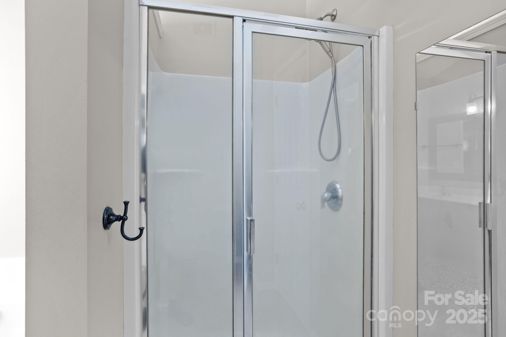 10825 Traders Court Davidson, NC 28036 - Photo 18 of 36 a bathroom with a glass shower door