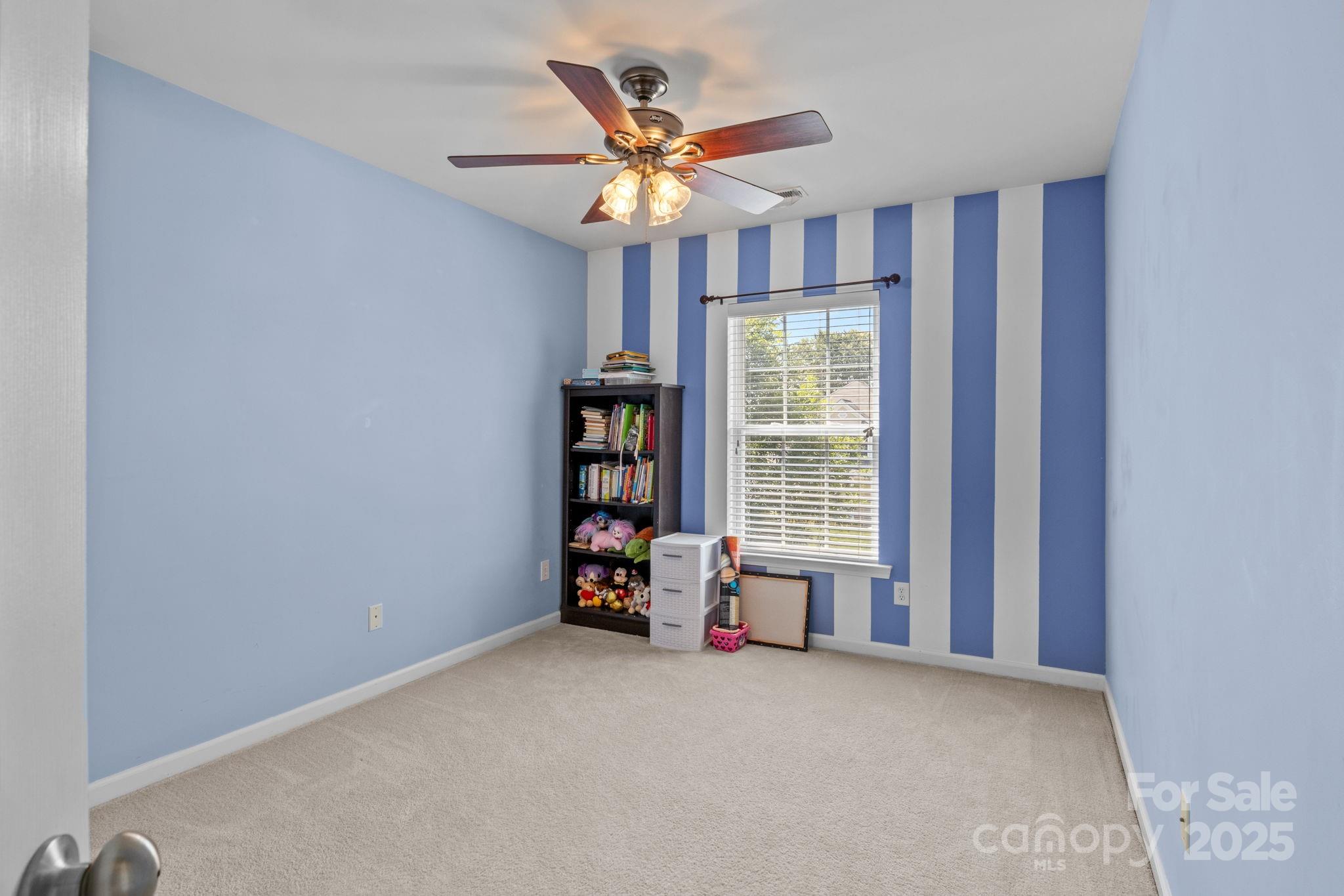 10825 Traders Court Davidson, NC 28036 - Photo 20 of 36 a view of livingroom with a ceiling fan and window