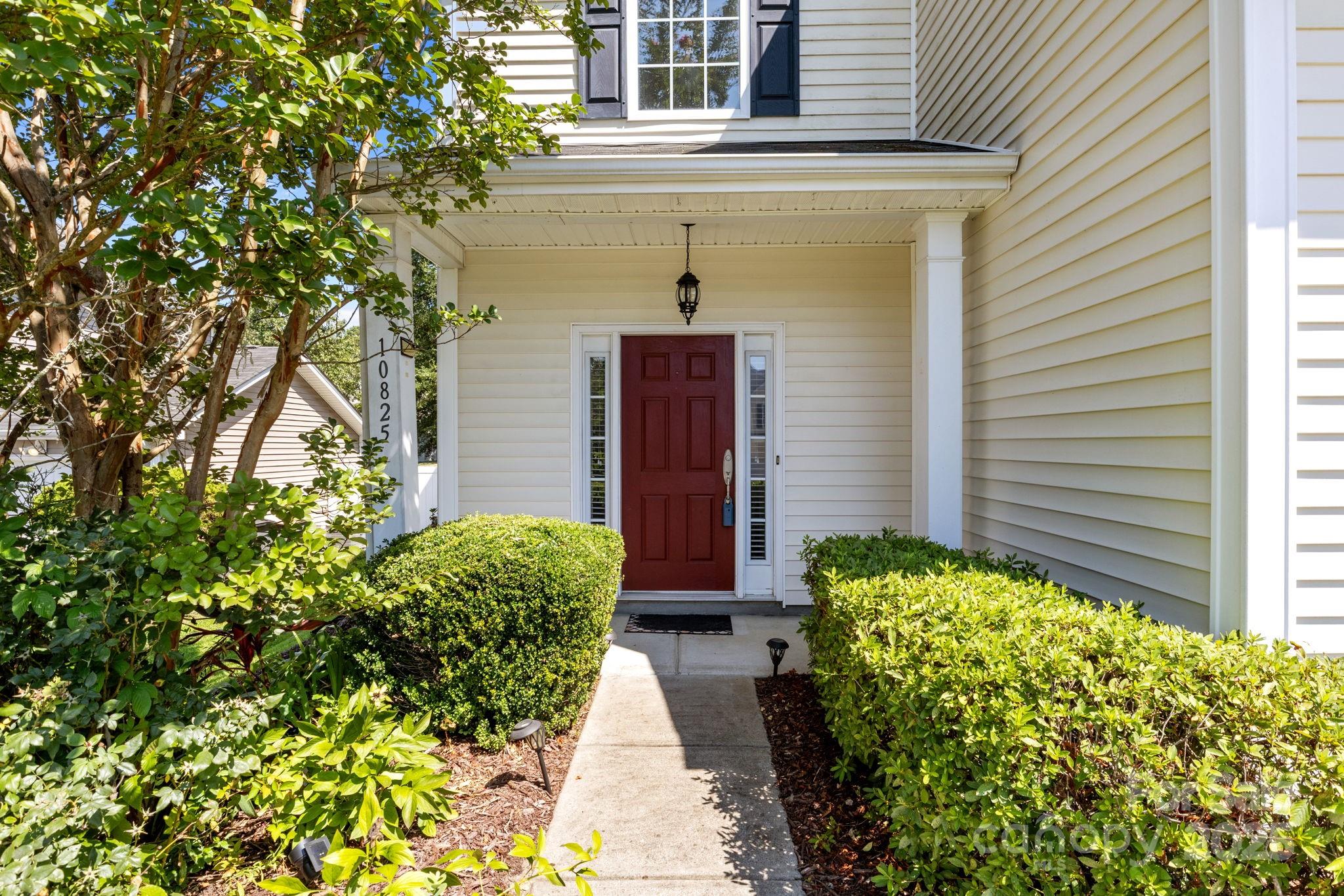 10825 Traders Court Davidson, NC 28036 - Photo 2 of 36 a front view of a house with garden