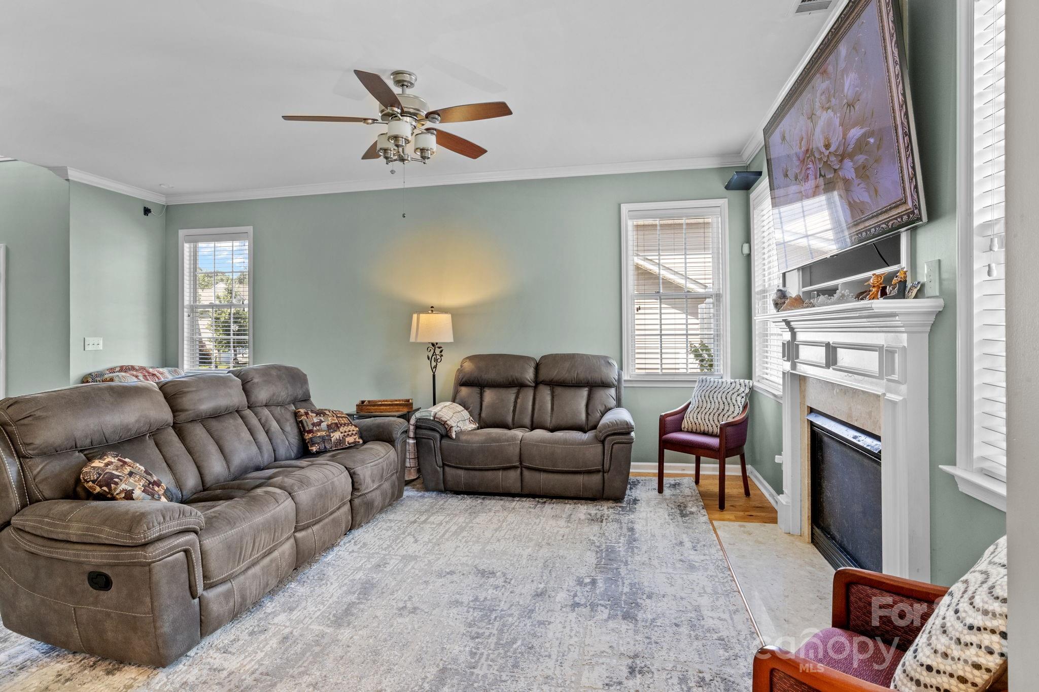 10825 Traders Court Davidson, NC 28036 - Photo 8 of 36 a living room with furniture fireplace and a window