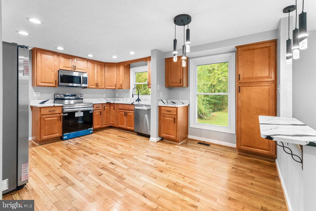 10401 Bald Hill Road Bowie, MD 20721 - Photo 17 of 44 Modern kitchen with warm wood accents.