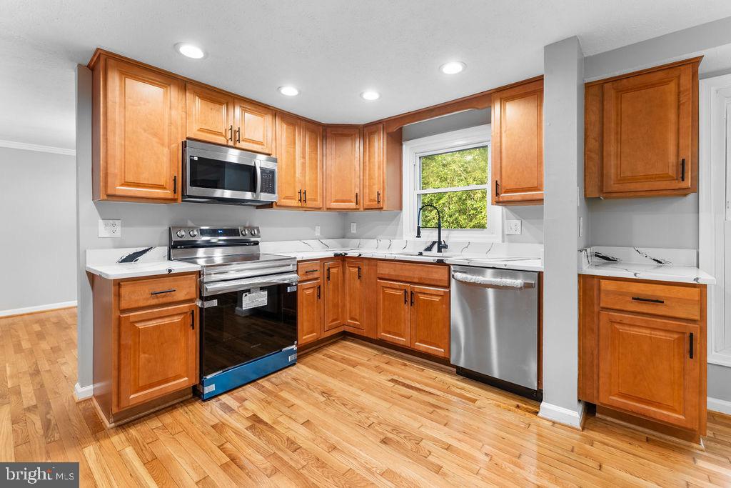 10401 Bald Hill Road Bowie, MD 20721 - Photo 19 of 44 Modern kitchen with warm wood accents.
