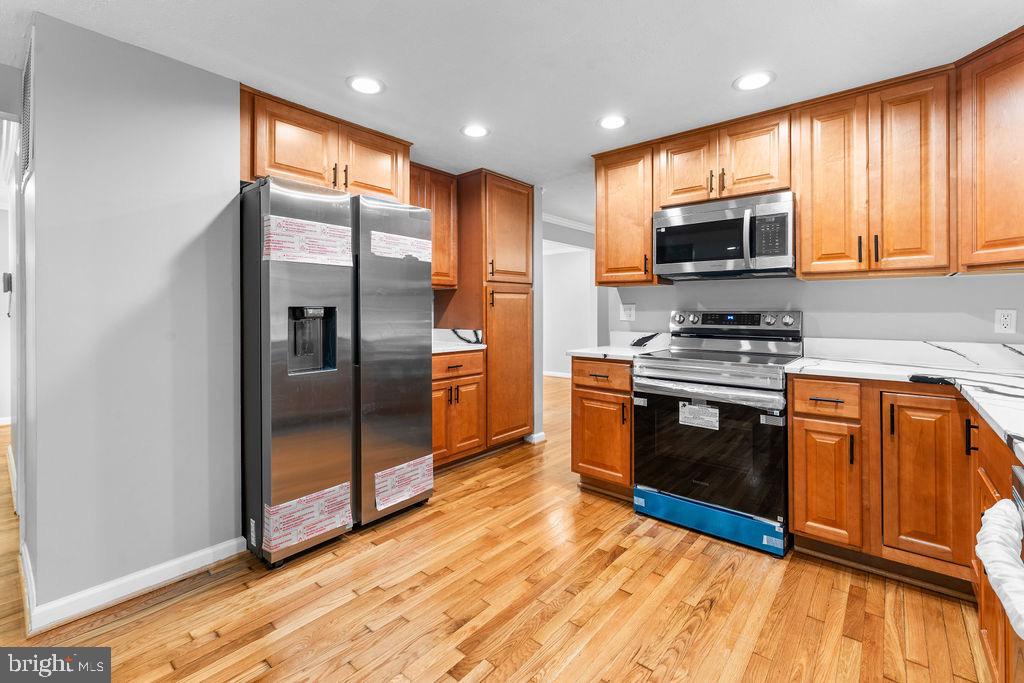 10401 Bald Hill Road Bowie, MD 20721 - Photo 20 of 44 Modern kitchen with sleek cabinetry and applian...
