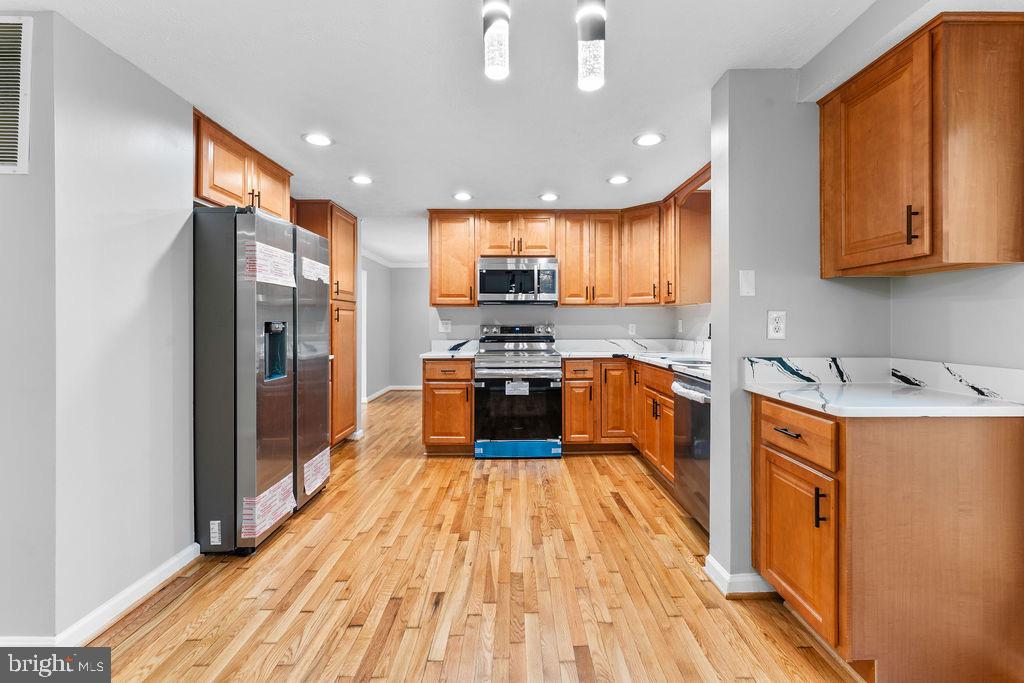 10401 Bald Hill Road Bowie, MD 20721 - Photo 21 of 44 Modern kitchen with warm wood accents.