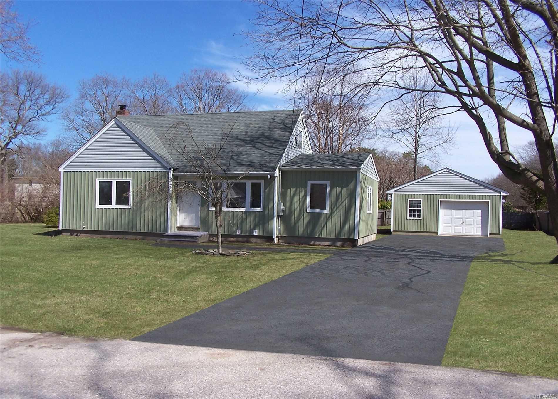a front view of a house with a garden and yard