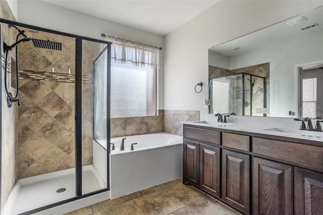 a bathroom with a tub sink and mirror