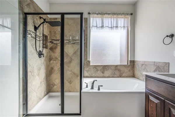 a bathroom with a tub and shower