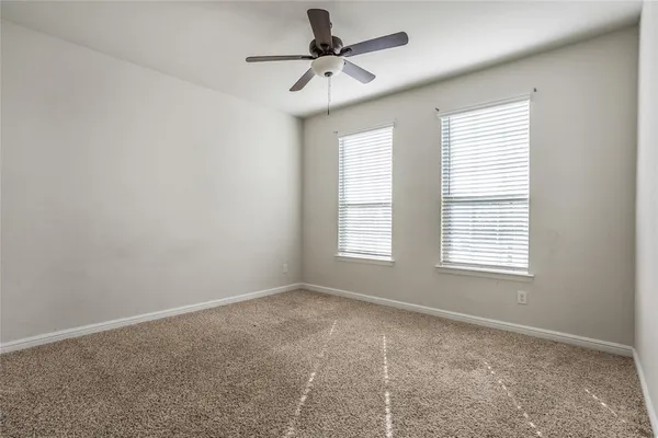 a view of a livingroom with a ceiling fan and window