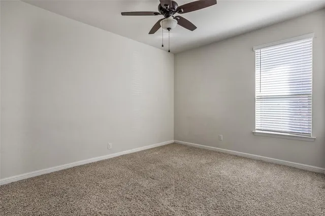a view of an empty room and a window