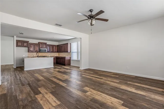 a view of a kitchen with a stove cabinets and wooden floor