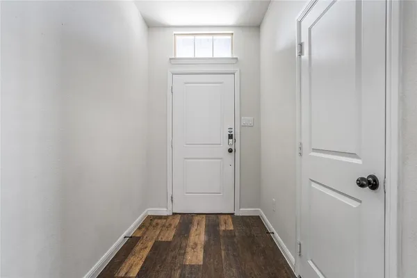 a view of a closet area with hardwood floor