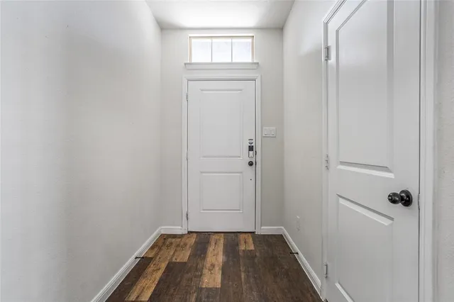 a view of a closet area with hardwood floor