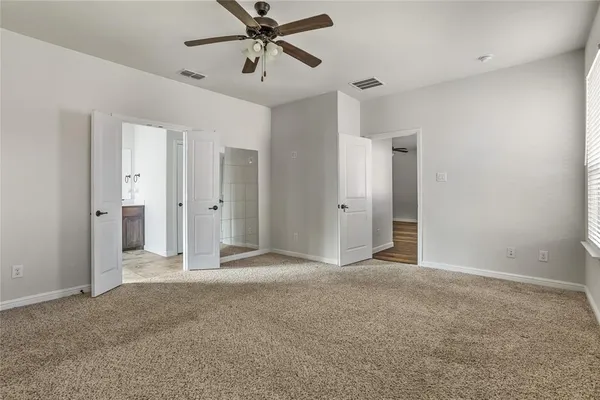 a view of empty room with ceiling fan